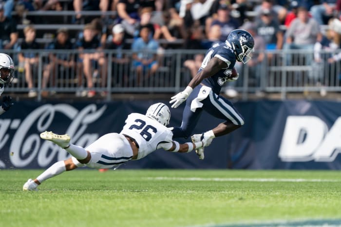 Oct 16, 2021; East Hartford, Connecticut, USA; Yale Bulldogs linebacker Rodney Thomas II (26) tackles Connecticut Huskies running back Kevin Mensah (34) during the second half at Rentschler Field at Pratt & Whitney Stadium.